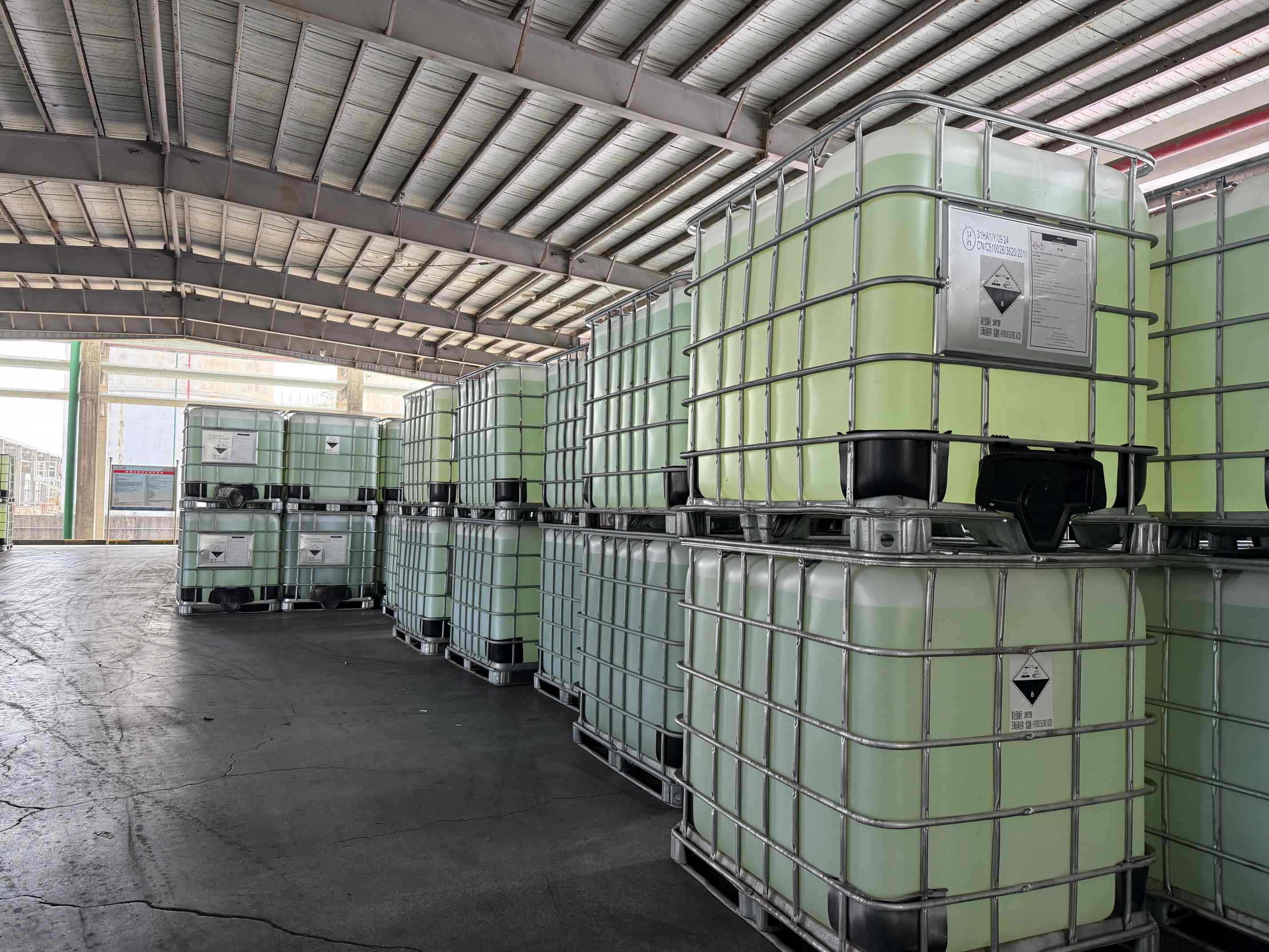 IBC chemical containers arranged in a warehouse